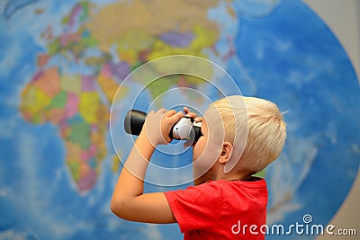 Happy child with binoculars are dreaming about traveling, journey. Tourism and travel concept. Creative background. Stock Photo