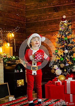 Happy child decorating Christmas tree. Cute little child near Christmas tree. Christmas decorations. Kids enjoy the Stock Photo