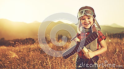 happy child dreams of traveling and playing with an airplane pilot aviator in outdoor Stock Photo