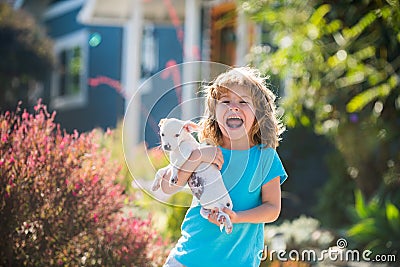 Happy child embraces pet dog. Embrace tenderness puppies. Hug friends. Stock Photo