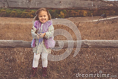 Happy child girl in autumn filed Stock Photo