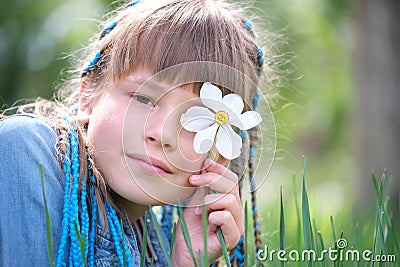 Happy child girl enjoying sweet smell of white narcissus flowers in summer garden Stock Photo