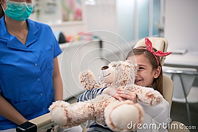 Happy child girl after examining tooth. girl visiting dentist Stock Photo