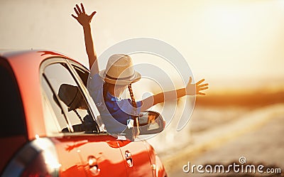 Happy child girl goes to summer travel trip in car Stock Photo