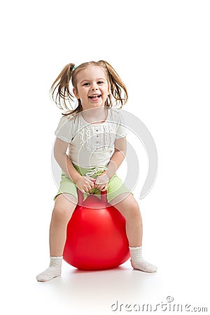 Happy little girl jumping on bouncing ball. Isolated on white. Stock Photo