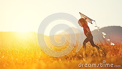 Happy child girl with a kite running on meadow in summer Stock Photo