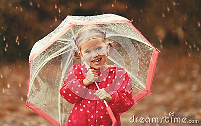 Happy child girl laughing with an umbrella in rain Stock Photo