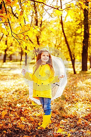 Happy child girl with an umbrella and rubber boots an autumn walk Stock Photo