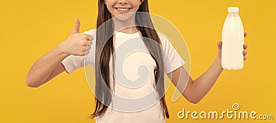 happy child hold dairy beverage product. teen girl going to drink milk. healthy lifestyle. Stock Photo