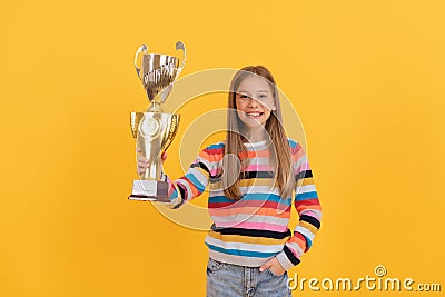 Happy child hold golden cup. achievement award. Celebrating school success. Stock Photo