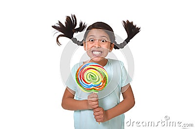 Happy child holding big lollipop candy with pony tails flying in freak crazy funny face Stock Photo