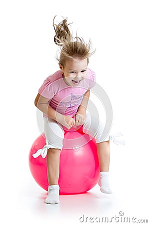 Happy child jumping on bouncing ball Stock Photo