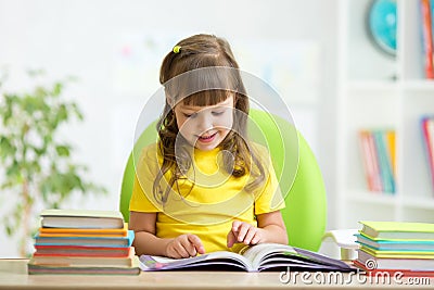 Happy child learning to read in nursery Stock Photo