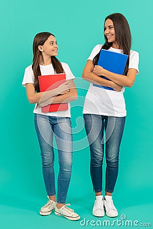 happy child and mother or teacher hold school workbook for studying, knowledge Stock Photo
