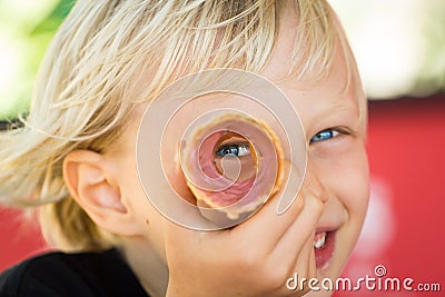 Happy child peeking through ice cream cone Stock Photo