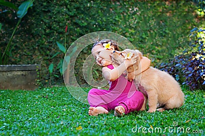 Happy child play and hug family pet - labrador puppy Stock Photo