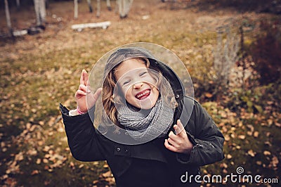 Happy child playing with leaves in autumn. Seasonal outdoor activities with kids Stock Photo