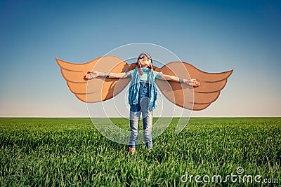 Happy child playing with toy paper wings Stock Photo