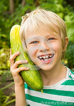 Happy child playing in vegetable garden Stock Photo