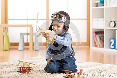 Happy child plays with toys airplane and dreams of becoming a pilot Stock Photo