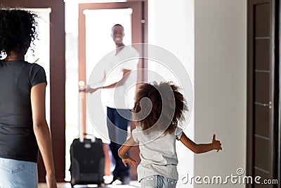 Happy child running to meet african dad coming back home Stock Photo