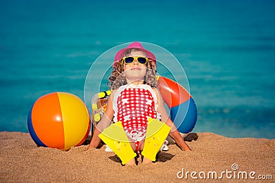 Happy child sitting on the beach Stock Photo