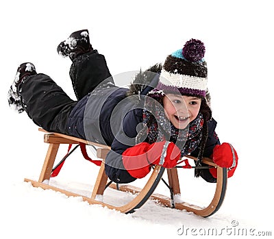 Happy child on sledge in winter, winter sports Stock Photo