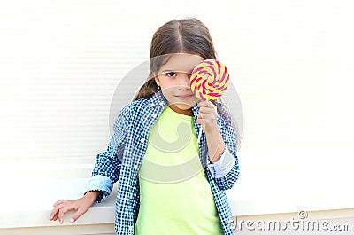 Happy child with sweet caramel lollipop having fun Stock Photo