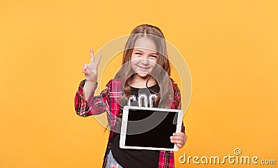 Happy child with tablet computer. Kid showing Stock Photo