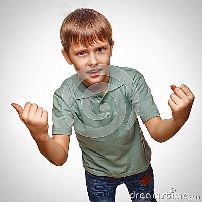 Happy child teen excited teenage boy shows hand so Stock Photo