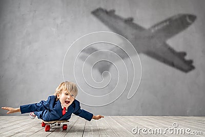 Happy child wants to fly. Imagination, freedom and motivation concept. Stock Photo