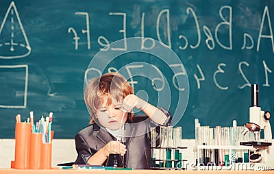 Happy childhood. Boy near microscope and test tubes school classroom. Knowledge concept. Knowledge day. Kid study Stock Photo