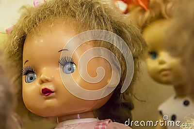 Happy childhood concept: retro toys, doll with blue eyes close-up Stock Photo