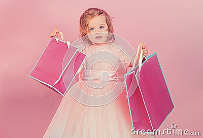 Happy childhood of little girl. Kid shopping. shopping bags. Christmas gift. Thanks for your purchase. big sale in Stock Photo