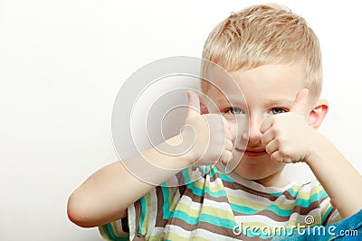 Happy childhood. Smiling blond boy child kid showing thumb up Stock Photo