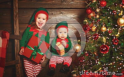 happy children brother and sister elf, helper of Santa with Christmas gifts Stock Photo