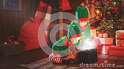 happy children brother and sister elf, helper of Santa with Christmas magic gifts Stock Photo