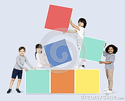 Happy children building colorful blocks Stock Photo