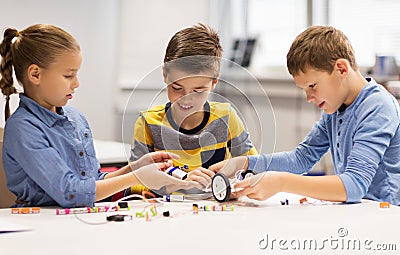 Happy children building robots at robotics school Stock Photo