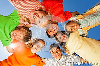 Happy children close in circle on sky background Stock Photo