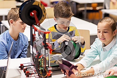 Happy children with 3d printer at robotics school Stock Photo