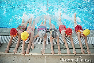 Happy children kids group at swimming pool class learning to swim Stock Photo