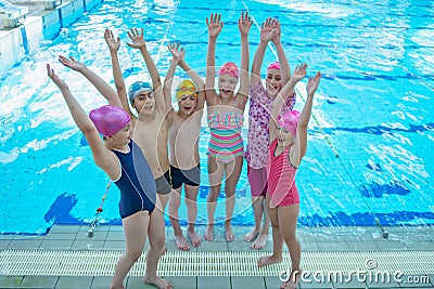 Happy children kids group at swimming pool class learning to swim Stock Photo