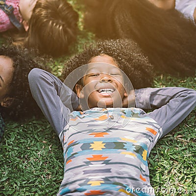 Happy children kids laying on grass Stock Photo