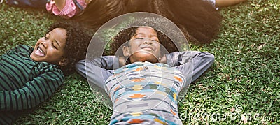 Happy children kids laying on grass in park Stock Photo