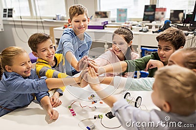 Happy children making high five at robotics school Stock Photo