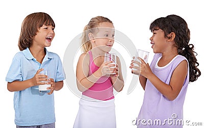 Happy, children and milk in glasses with nutrition, health and wellness in white background of studio. Calcium, drink Stock Photo