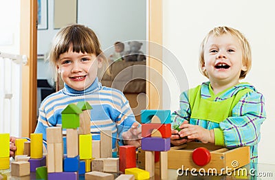 Happy children playing with blocks in home Stock Photo
