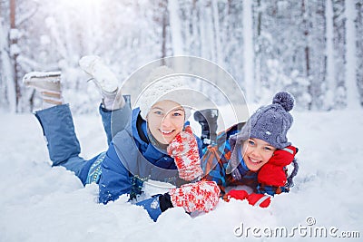 Happy children playing on snowy winter day. Stock Photo