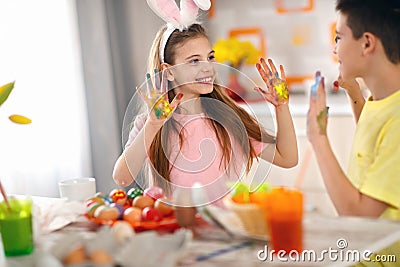 Children`s hands dirty from paint for eggs Stock Photo